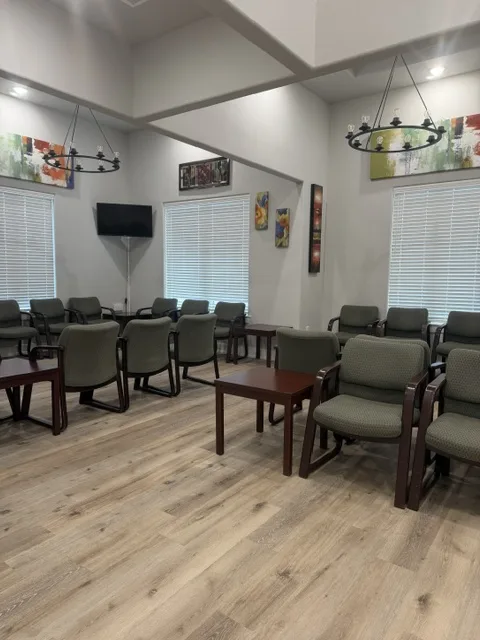 Waiting room with green chairs at Precision Longevity and Family Medicine